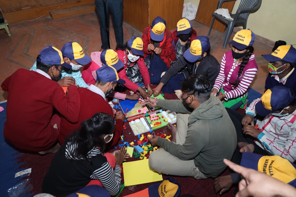 Adolescents involved in a group model-making activity to design their public space collaboratively.