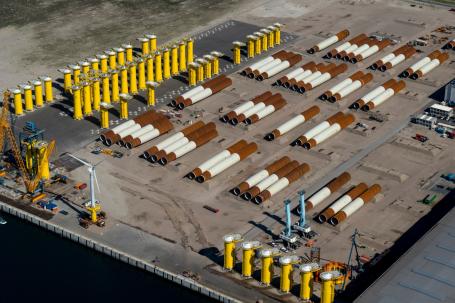 Foundations for wind turbines are stored at the dock. Photo by Aerovista Luchtfotografie/Shutterstock. 
