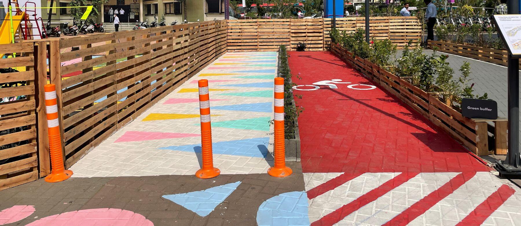 green street edge segregating the pedestrian and vehicular lanes to ensure pedestrian safety